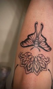 Butterfly and ornamental flower tattoo design