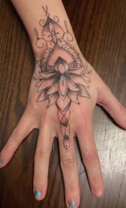 Floral tattoo placed across the hand